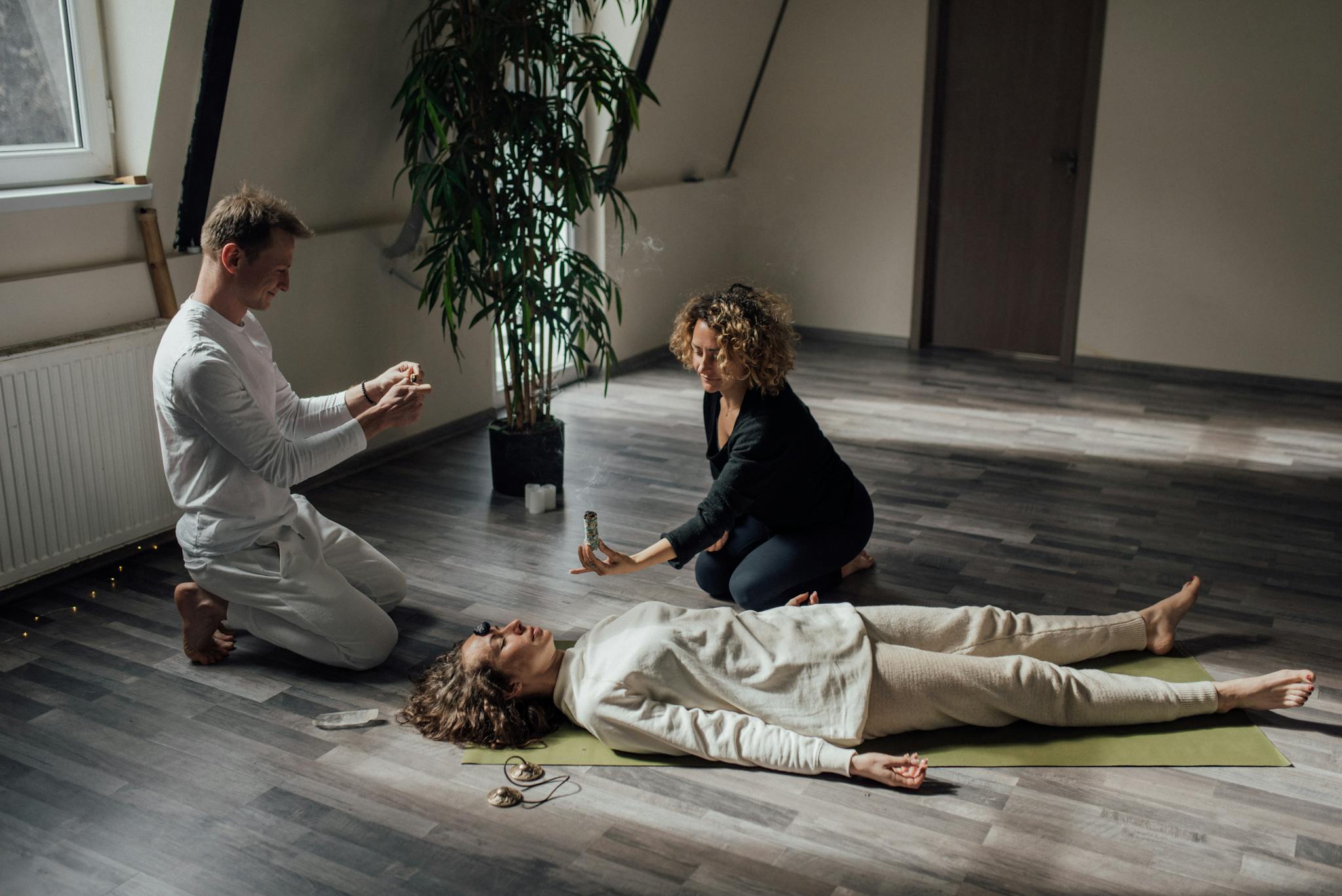 Meditation session indoors with incense and wellness practices.